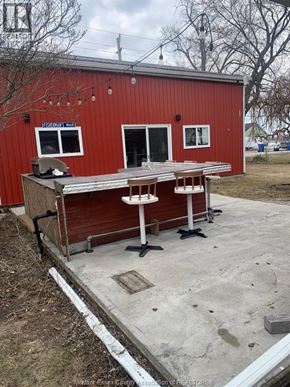 Amherstburg apartment for rent - A red building with a white table in front of it.