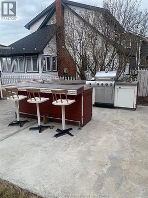 Amherstburg apartment for rent - A red and white outdoor kitchen with a grill and sink.