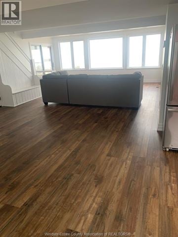 Amherstburg apartment for rent - A living room with a grey couch and wooden floors.