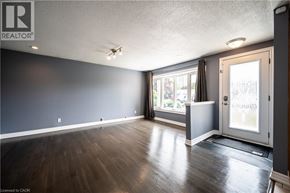 Kitchener apartment for rent - A room with a wooden floor and a sliding glass door.