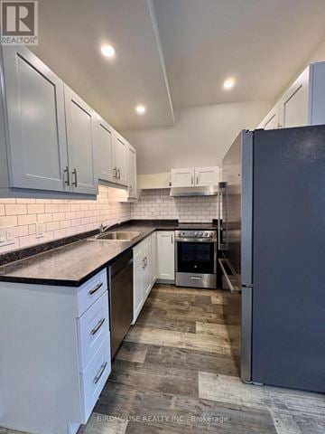 Kawartha Lakes (Lindsay) apartment for rent - A kitchen with white cabinets and a black fridge.