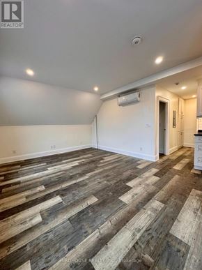 Kawartha Lakes (Lindsay) apartment for rent - A room with wooden flooring and white walls.