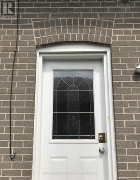 Newmarket (Bristol-London) apartment for rent - A white door with a glass window and a metal handle.
