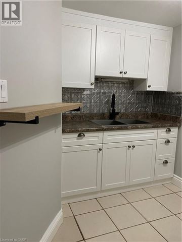 Waterloo apartment for rent - A kitchen with white cabinets and a granite countertop.