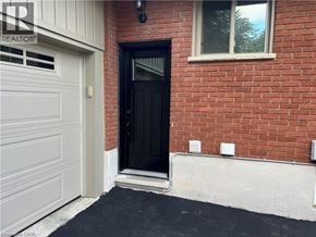 Waterloo apartment for rent - A black door is on the left side of a red brick house.