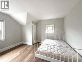 Windsor apartment for rent - A white metal bed frame in a room with light colored walls.