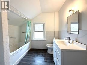Windsor apartment for rent - A bathroom with a toilet, sink, and bathtub.