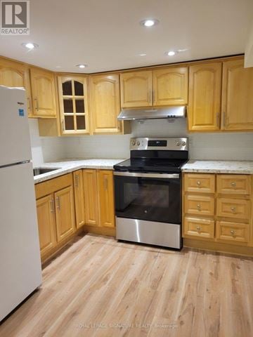 Markham (Unionville) apartment for rent - A kitchen with wooden cabinets and a white refrigerator.