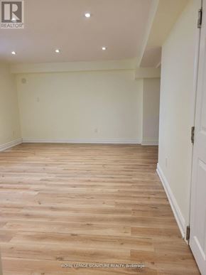 Markham (Unionville) apartment for rent - A room with wooden flooring and white walls.