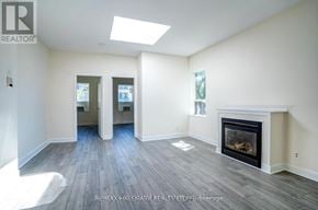 Toronto (Moss Park) apartment for rent - A spacious living room with a fireplace and hardwood floors.