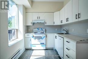Toronto (Moss Park) apartment for rent - A white kitchen with a dishwasher and a washing machine.