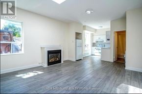 Toronto (Moss Park) apartment for rent - A spacious living room with a fireplace and hardwood floors.