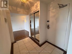 Toronto (Flemingdon Park) condo for rent - A hallway with a sliding door and a chandelier.