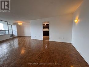 Toronto (Flemingdon Park) condo for rent - A room with wooden flooring and white walls, with a logo of REALTOR in the top left corner.