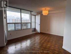 Toronto (Flemingdon Park) condo for rent - A room with a wooden floor and a large window.