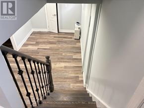 Toronto (Birchcliffe-Cliffside) apartment for rent - A staircase with a wooden floor and a metal railing.