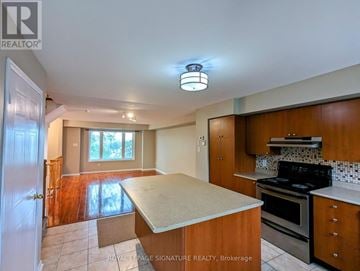 Mississauga (Churchill Meadows) townhouse for rent - A kitchen with a stove top oven and a counter top.