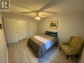 Kawartha Lakes (Bobcaygeon) apartment for rent - A bedroom with a bed, chair, and ceiling fan.