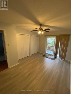 Kawartha Lakes (Bobcaygeon) apartment for rent - A room with a ceiling fan and light, wooden floors, and a door leading outside.