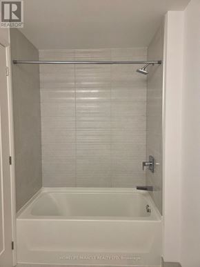 Hamilton (Corktown) condo for rent - A white bathroom with a glass shower door.