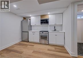 Cambridge apartment for rent - A kitchen with white cabinets and a wooden backsplash.