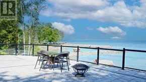 Tiny apartment for rent - A table and chairs are set up on a patio overlooking a pool.