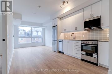 Oakville (Wm Westmount) condo for rent - A kitchen with white cabinets and a black stove top oven.