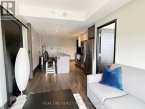 Waterloo condo for rent - A modern kitchen with granite countertops and a large island.