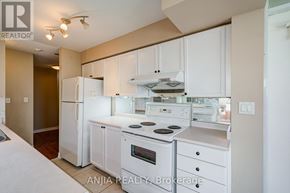Toronto (Bayview Village) condo for rent - A white kitchen with a refrigerator, oven, and microwave.