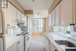 Toronto (Bayview Village) condo for rent - A kitchen with white appliances and beige cabinets.