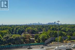 Toronto (Bayview Village) condo for rent - A view of a city skyline from a high vantage point with a clear blue sky.