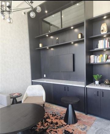 Oakville (Wm Westmount) condo for rent - A modern living room with a grey sofa and a black coffee table.