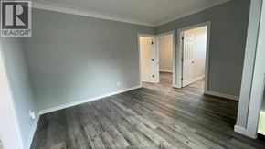 Windsor apartment for rent - A room with wooden flooring and two white doors.