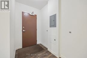 Port Hope apartment for rent - A brown door is in a white hallway.