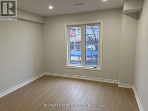 Bradford West Gwillimbury (Bradford) apartment for rent - A room with a window showing a view of a pool and buildings outside.