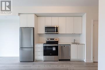 Milton (Fo Ford) condo for rent - A kitchen with a refrigerator, oven, and microwave.