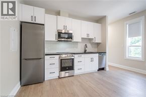 Hamilton apartment for rent - A kitchen with white cabinets and stainless steel appliances.