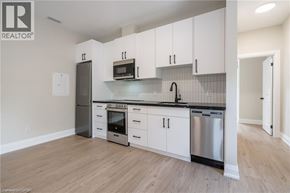 Hamilton apartment for rent - A kitchen with white cabinets and stainless steel appliances.