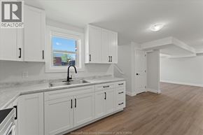 Windsor apartment for rent - A kitchen with white cabinets and a marble countertop.