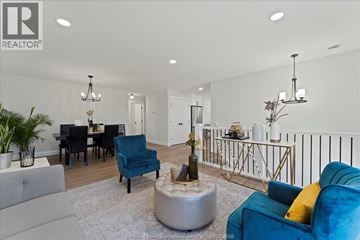 Windsor duplex for rent - A living room with a blue chair and a grey sofa.