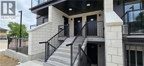 Waterloo townhouse for rent - A building with a black railing and a glass window.