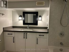 Toronto (Trinity-Bellwoods) townhouse for rent - A bathroom with a sink, mirror, and cabinets.