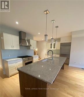 Ottawa apartment for rent - A modern kitchen with a granite countertop and stainless steel appliances.