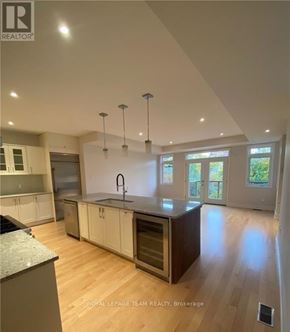 Ottawa apartment for rent - A modern kitchen with wooden floors and a large island.