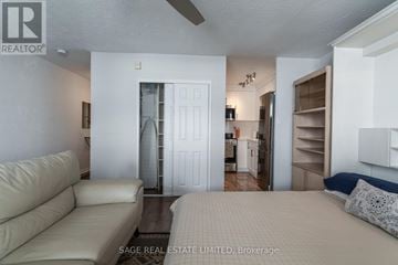 Toronto (Leaside) condo for rent - A living room with a couch and a bed.