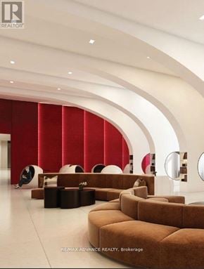 Toronto (Agincourt South-Malvern West) condo for rent - A modern living room with a curved wall and a person sitting on a chair.