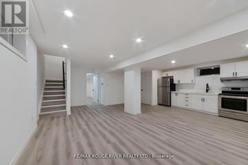 Oshawa (Vanier) duplex for rent - A spacious kitchen with white cabinets and stainless steel appliances.