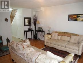 Markham (Greensborough) townhouse for rent - A living room with a couch, chair, and television.