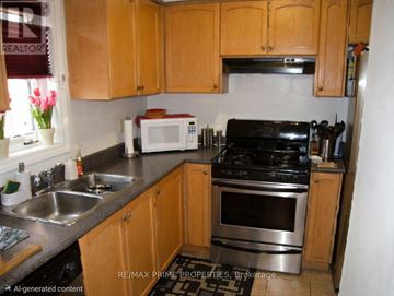 Markham (Greensborough) townhouse for rent - A kitchen with wooden cabinets and stainless steel appliances.
