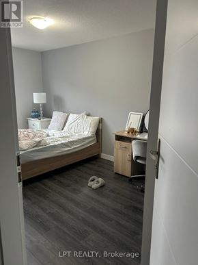Waterloo townhouse for rent - A bedroom with a bed, desk, and chair.